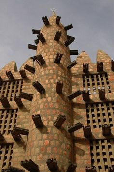 a very tall brick building with lots of windows on it's face and sides