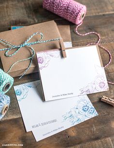 two brown boxes with blue and pink flowers on them next to twine of twine