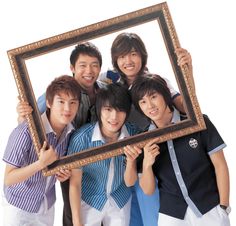 group of young men holding up a wooden frame with an image of them in it