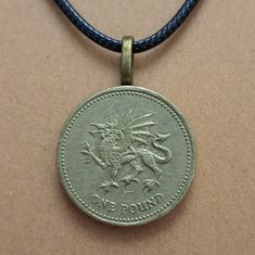 Genuine British Ten Pence Coin on an 18" leather cord; secures with lobster claw clasp. Coin features image of a dragon Since we use genuine foreign coins necklaces may vary slightly from the photo due to unique wear and aging, but it will still be a close match. Whether this purchase is to help you connect to your roots, keep a precious dream or memory alive, or to remind you of a loved one we are glad to be a part of your journey! Find us on Facebook and Instagram @lostcoinjewelryco Orders are Foreign Coins, Mythical Creature, Dragon Slayer, Coin Necklace, Mythical Creatures, Leather Cord, Lobster Claw, Jewelry Necklace Pendant, United Kingdom