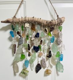 a wind chime made out of sea glass and driftwood