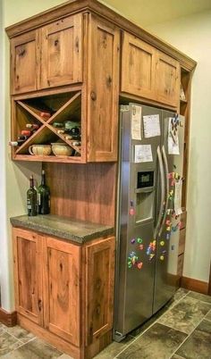 a refrigerator freezer sitting inside of a kitchen next to a wooden cabinet and counter