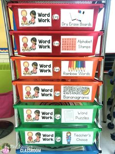 four red and green bins with words on them in front of a classroom desk