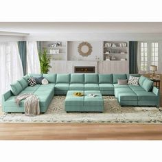 a living room filled with furniture and a large rug on top of a hard wood floor