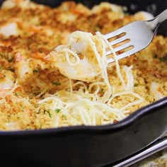 a close up of food in a pan with a fork