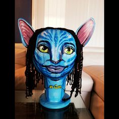 a blue cat head sitting on top of a table