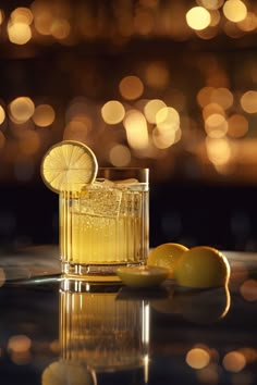 a glass filled with lemonade sitting on top of a table