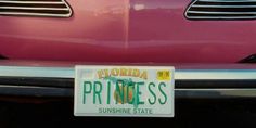 a license plate on the front of a pink car that says florida princess sunshine state