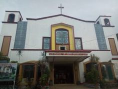 a large white building with a cross on the top