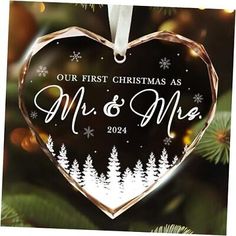 a heart shaped ornament hanging from a christmas tree with the words mr and mrs printed on it