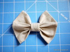 a close up of a bow tie on a cutting board with blue tiles in the background