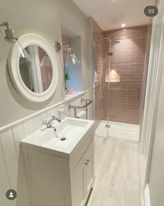 a white sink sitting next to a walk in shower