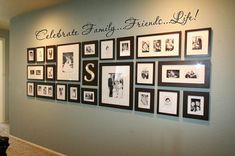 a wall with many framed pictures on it