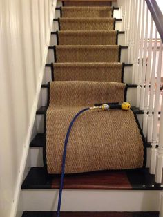 a hose is attached to the carpeted stairs