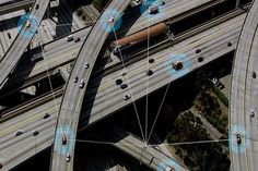 an aerial view of multiple roads with cars on one side and two lanes to the other