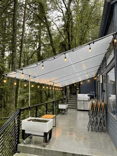 an outdoor patio with lights strung from the ceiling