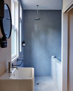 a bathroom with a sink, mirror and bathtub