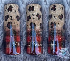 three red, white and blue nail polishes with leopard prints on them sitting on a fur surface