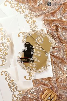 wedding stationery with gold foil on white paper and golden sequins around it