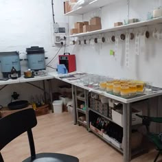 there are many cups on the table in this room with shelves full of bottles and glasses