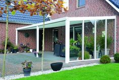 a brick house with glass walls and white trim