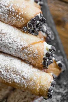 powdered sugar and blueberries are piled on top of each other in this pastry dish