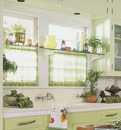 a kitchen filled with lots of green cupboards