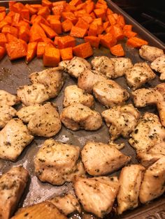 chicken and carrots cooking in a pan on the stove