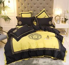 a bed with black and yellow comforters in a room