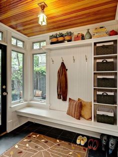 a white bench sitting under a window next to a wooden ceiling with lots of windows