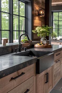 a kitchen with wooden cabinets and black counter tops, along with a large window over the sink