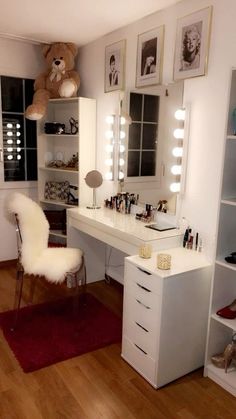 a white vanity with lighted lights and a teddy bear