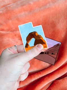 Hand holding two travel stickers of red rocks and arches national park Wanderlust Stickers, Sticker Designs, Arches National Park, Star Stickers, Custom Stickers, Sticker Design