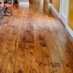 a wooden floor in a house with yellow walls