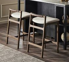 three stools are sitting in front of a counter