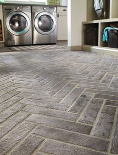 a washer and dryer sitting in a room next to each other on the floor