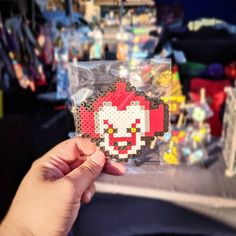 a person holding up a piece of pixel art