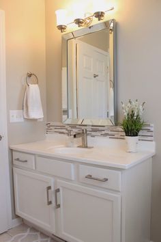 a bathroom sink with a mirror above it