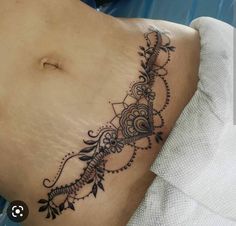 a woman with a tattoo on her stomach