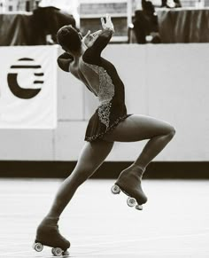 a woman in a leotard doing a trick on a skateboard while people watch from the sidelines