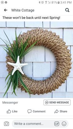 a white starfish hanging from a rope wreath on a brick wall next to a message