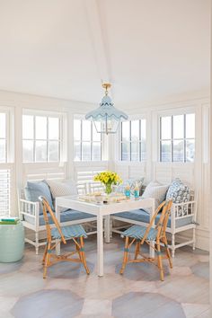 a white table with blue chairs around it