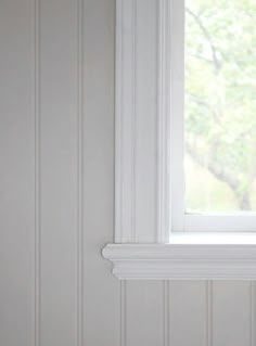 a cat sitting on top of a window sill