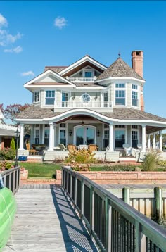 a large white house sitting on top of a lush green field