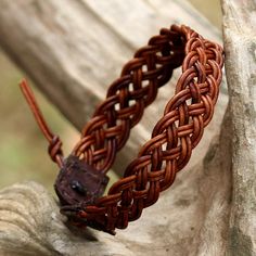 Featuring a handwoven design by local Thai artisans, this wristband bracelet is crafted from leather cord in a brown color. Chaloemphon presents the adjustable bracelet, closing with a silver button that is handcrafted by Karen hill tribe silversmiths. Woven Leather Bracelet, Braided Leather Bracelet Tutorial, Diy Bracelets For Men, Leather Bracelet Diy, Leder Diy, Leather Braiding, Diy Leather Bracelet, Braid Jewelry, Leather Cord Bracelets