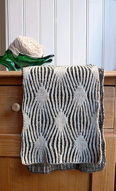 a close up of a knitted object on a dresser