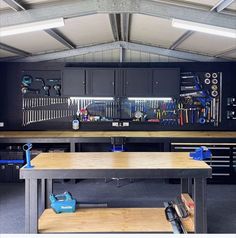 an organized garage with work benches and tools