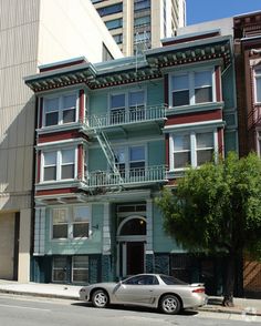 a car parked in front of a multi - story building