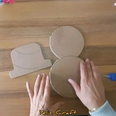 someone is making a mickey mouse out of cardboard and glues it on the table