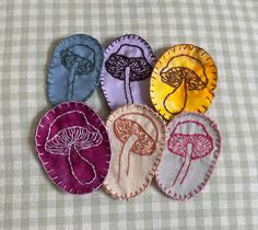 four different types of fabric appliques on a tablecloth with gingham checkered cloth